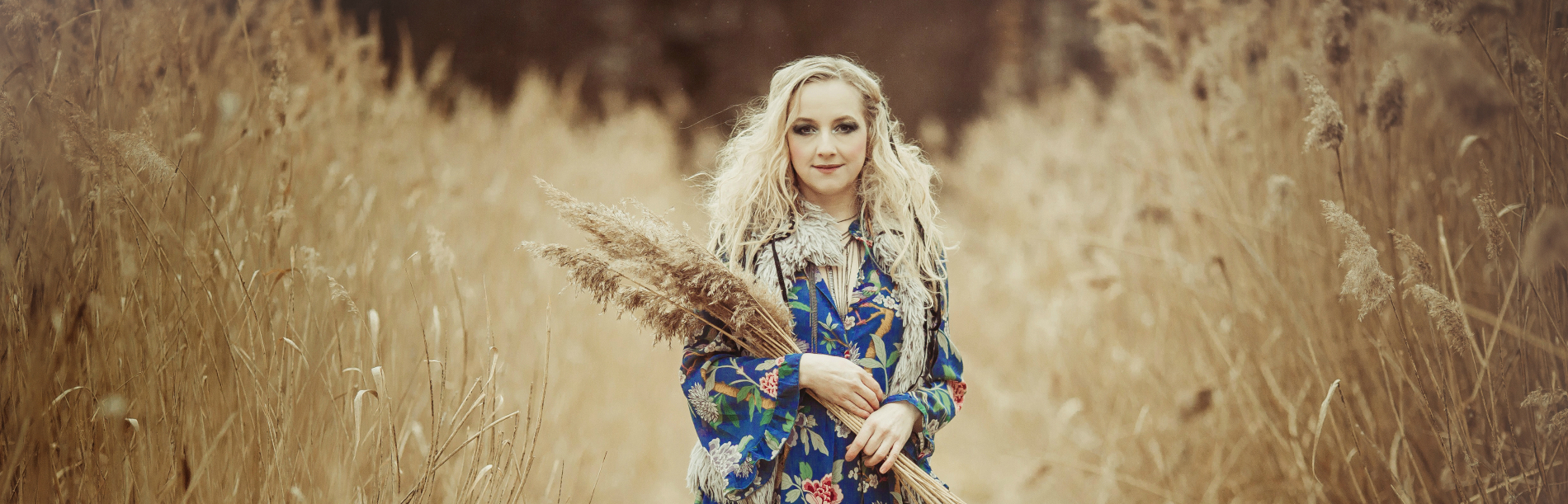 Veronika standing in a field with flowers